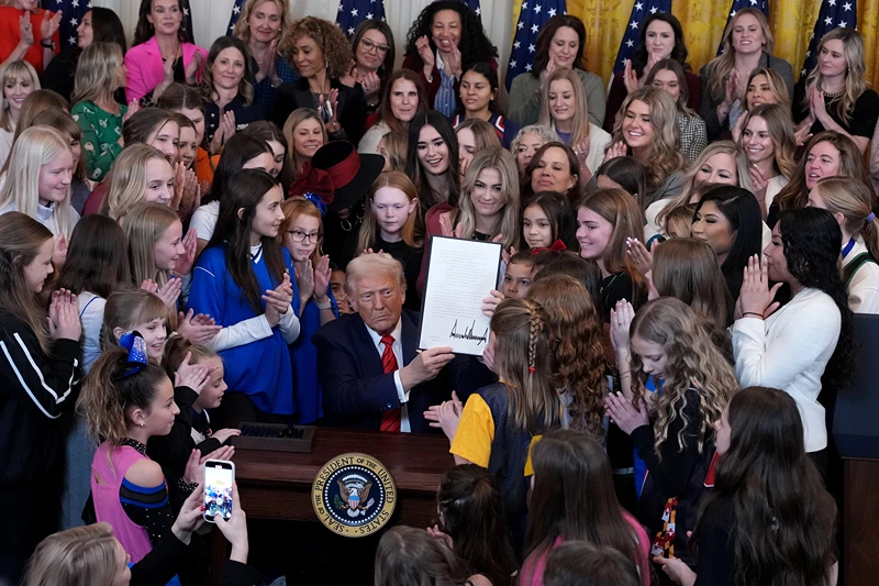 WASHINGTON, DC - FEBRUARY 05: U.S. President Donald Trump joined by women athletes signs the “No Men in Women’s Sports” executive order in the East Room at the White House on February 5, 2025 in Washington, DC. The executive order, which Trump signed on National Girls and Women in Sports Day, prohibits transgender women from competing in women’s sports and is the third order he has signed that targets transgender people. (Photo by Andrew Harnik/Getty Images)