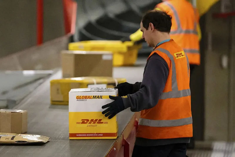 LEIPZIG, GERMANY - FEBRUARY 27: A worker sorts parcels during the night at the DHL hub on February 27, 2014 in Leipzig, Germany. The soon to be expanded hub handles 2,000 tons of cargo or 100.000 parcels and documents per weekday, up to 60 cargo planes land every weeknight. (Photo by Marco Prosch/Getty Images)