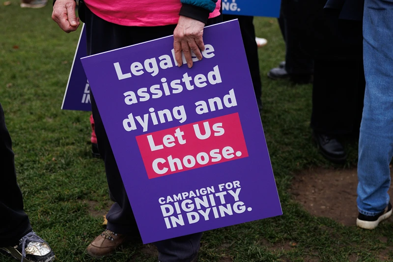 Campaigners in Parliament Square in favour of the proposed bill to legalise assisted dying, on October 16, 2024 in London, England. The 'Terminally Ill Adult (End of Life) Bill' seeks to help terminally ill people with six to 12 months left to live to end their lives legally. As a safeguarding measure, it proposes that a judge and two doctors would need to sign off on a patient's request for an assisted death. A recent poll showed a majority of the public would support assisted deaths for the terminally ill. (Photo by Dan Kitwood/Getty Images)