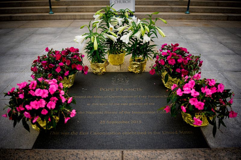 WASHINGTON, DC - APRIL 21: Flowers are placed around a plaque commemorating a 2015 visit from Pope Francis at the Basilica of the National Shrine of the Immaculate Conception in the wake of the the death of Pope Francis on April 21, 2025 in Washington, DC. The Vatican announced that Pope Francis, 88, died on Monday at 07:35 local time and "the Bishop of Rome, Francis, returned to the home of the Father". His death comes after he appeared in St Peter's Square on Easter Sunday, greeting thousands of worshippers. (Photo by Andrew Harnik/Getty Images)