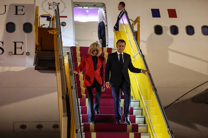 France's President Emmanuel Macron and his wife Brigitte Macron disembark from the plane upon their arrival at Noi Bai International Airport in Hanoi on May 25, 2025. French President Emmanuel Macron arrived in Hanoi on May 25, an AFP journalist saw, for the first leg of a Southeast Asia tour that will also see him travel to Indonesia and Singapore. (Photo by Ludovic MARIN / AFP) (Photo by LUDOVIC MARIN/AFP via Getty Images)