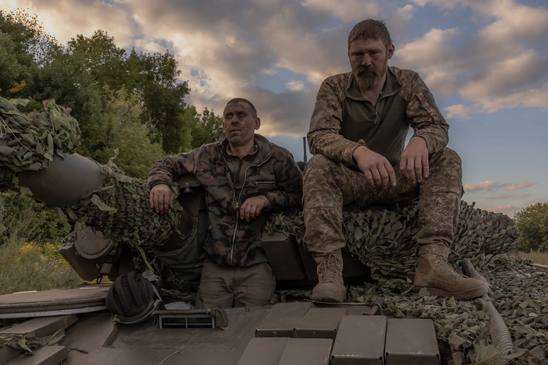 TOPSHOT - Ukrainian tank crew take a break while operating a Soviet-made T-72 tank in the Sumy region, near the border with Russia, on August 12, 2024, amid the Russian invasion of Ukraine. Ukraine launched a surprise offensive into the Russian border region of Kursk on August 6, 2024, capturing over two dozen towns and villages in the most significant cross-border attack on Russian soil since World War II. Ukraine's military chief Oleksandr Syrsky told President Volodymyr Zelensky in a video posted on August 12, 2024 that his troops now control about 1,000 square kilometres of Russian territory and are continuing "offensive operations". (Photo by Roman PILIPEY / AFP) (Photo by ROMAN PILIPEY/AFP via Getty Images)