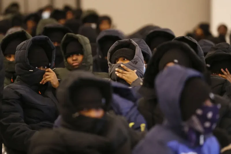 TOPSHOT - More than 170 irregular Nigerian migrants wait to board buses from the offices of the department of combating illegal migration, tasked with coordinating deportations of foreigners who are in the country illegally with the International Organization for Migration (IOM), to Tripoli's Mitiga International Airport on March 18, 2025. (Photo by Mahmud Turkia / AFP) (Photo by MAHMUD TURKIA/AFP via Getty Images)
