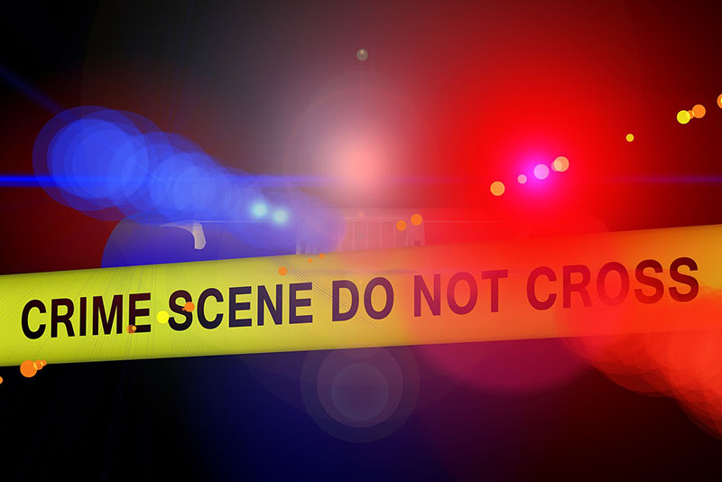 Crime scene police tape in front of blue and red police lights at night. Image by Gerd Altmann