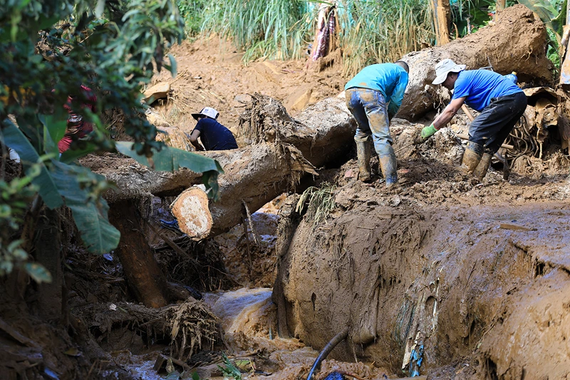Men work to clear the area after a landslide in Bello, Antioquia Department, Colombia, on June 25, 2025. A landslide triggered by heavy rains killed at least 10 people and injured eight others on June 24 near the Colombian city of Medellin, government officials said. Locals were warned to evacuate the area in the municipality of Bello, which remained vulnerable to landslides, the governor of the Antioquia Department, Andres Julian Rendon, said while confirming the casualties. (Photo by JAIME SALDARRIAGA / AFP) (Photo by JAIME SALDARRIAGA/AFP via Getty Images)