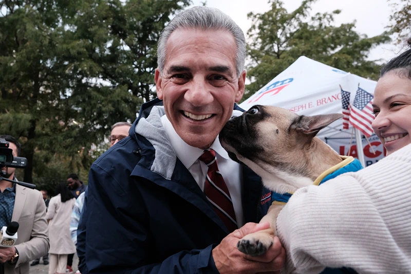 New Jersey Republican gubernatorial candidate Jack Ciattarelli gets a kiss from a pug named Romeo as he participates in a campaign event with local residents on October 27, 2021 in Hoboken, New Jersey. Ciattarelli, who is running against Democratic incumbent Phil Murphy, has promised to reduce taxes and a streamline the state budget if elected. (Photo by Spencer Platt/Getty Images)