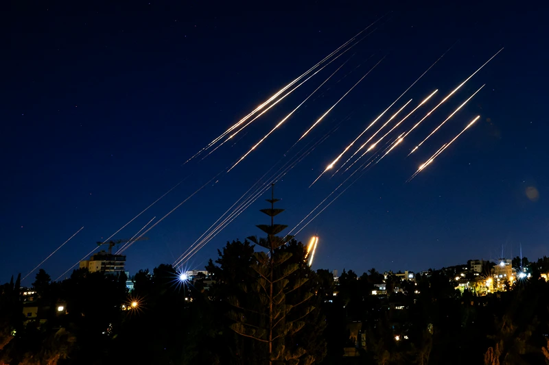 TOPSHOT - Missiles fired from Iran are pictured in the night sky over Jerusalem on June 14, 2025. Israel and Iran exchanged fire on June 14, a day after Israel unleashed an unprecedented aerial bombing campaign that Iran said hit its nuclear facilities, "martyred" top commanders and killed dozens of civilians (Photo by Menahem Kahana / AFP) (Photo by MENAHEM KAHANA/AFP via Getty Images)