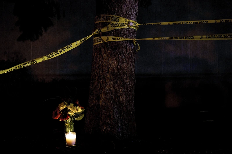 Flowers and a candle are seen near a police line surrounding the Tree of Life Congregation October 30, 2018 in Pittsburgh, Pennsylvania. US President Donald Trump and his wife Melania will visit Pittsburgh on October 30, 2018 to show support after a gunman killed 11 people in a massacre at the synagogue on October 27, 2018. (Photo by Brendan Smialowski / AFP) (Photo by BRENDAN SMIALOWSKI/AFP via Getty Images)
