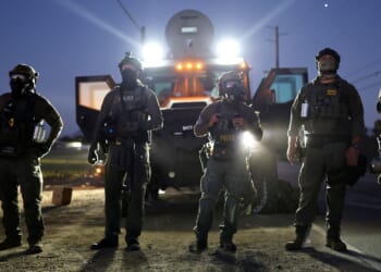 Federal agents block people protesting an ICE immigration raid at a cannabis farm in Camarillo, California, on Thursday.