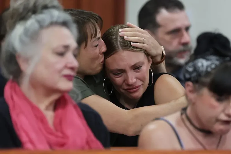 BOISE, IDAHO - JULY 23: Dylan Mortensen is comforted after speaking at the sentencing hearing of Bryan Kohberger at the Ada County Courthouse on July 23, 2025 in Boise, Idaho. Kohberger pleaded guilty in exchange for being spared the death penalty for the stabbing of four University of Idaho students nearly three years ago. He faces up to four life sentences in prison. (Photo by Kyle Green-Pool/Getty Images)