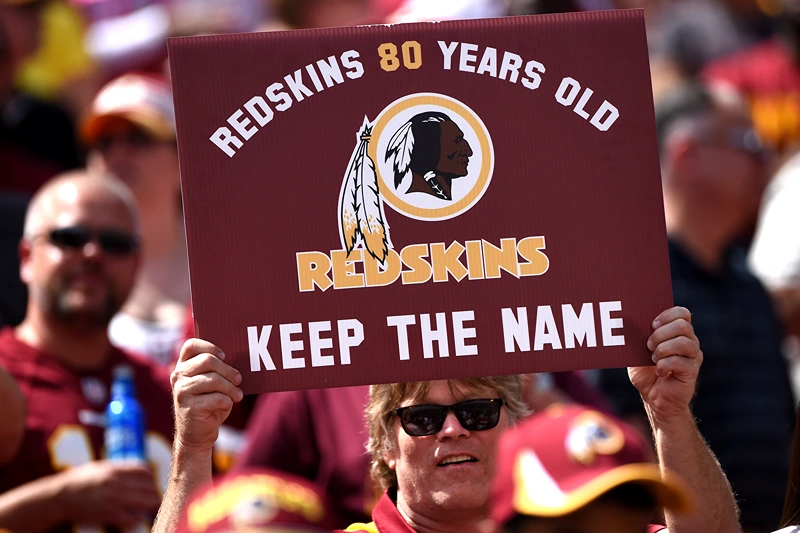 LANDOVER, MD - SEPTEMBER 14: A Washington Redskins fan holds up a sign to keep the Redskins name before they play the Jacksonville Jaguars at FedExField on September 14, 2014 in Landover, Maryland. The Washington Redskins won, 41-10. (Photo by Patrick Smith/Getty Images)