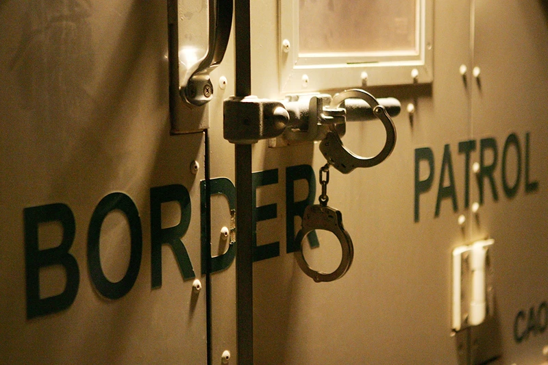 YUMA, AZ - MARCH 17: Handcuffs secure the back door of a US Customs and Border Protection border patrol vehicle loaded with suspected illegal immigrants on the California side of the Colorado River on March 17, 2006 near Yuma, Arizona. As Congress begins a new battle over immigration policy, U.S. Customs and Border Protection (CBP) border patrol agents in Arizona are struggling to control undocumented immigrants that were pushed into the region by the 1990?s border crack-down in California called Operation Gatekeeper. A recent study by the Pew Hispanic Center using Census Bureau data estimates that the U.S. currently has an illegal immigrant population of 11.5 million to 12 million, about one-third of them arriving within the past 10 years. More than half are from Mexico. Beefed-up border patrols and increased security are reportedly having the unintended result of deterring many from returning to their country of origin. (Photo by David McNew/Getty Images)