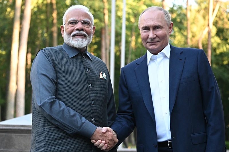 In this pool photograph distributed by the Russian state agency Sputnik, Russia's President Vladimir Putin welcomes Indian Prime Minister Narendra Modi for an informal meeting at the Novo-Ogaryovo state residence, outside Moscow, on July 8, 2024. (Photo by Sergei BOBYLYOV / POOL / AFP) (Photo by SERGEI BOBYLYOV/POOL/AFP via Getty Images)