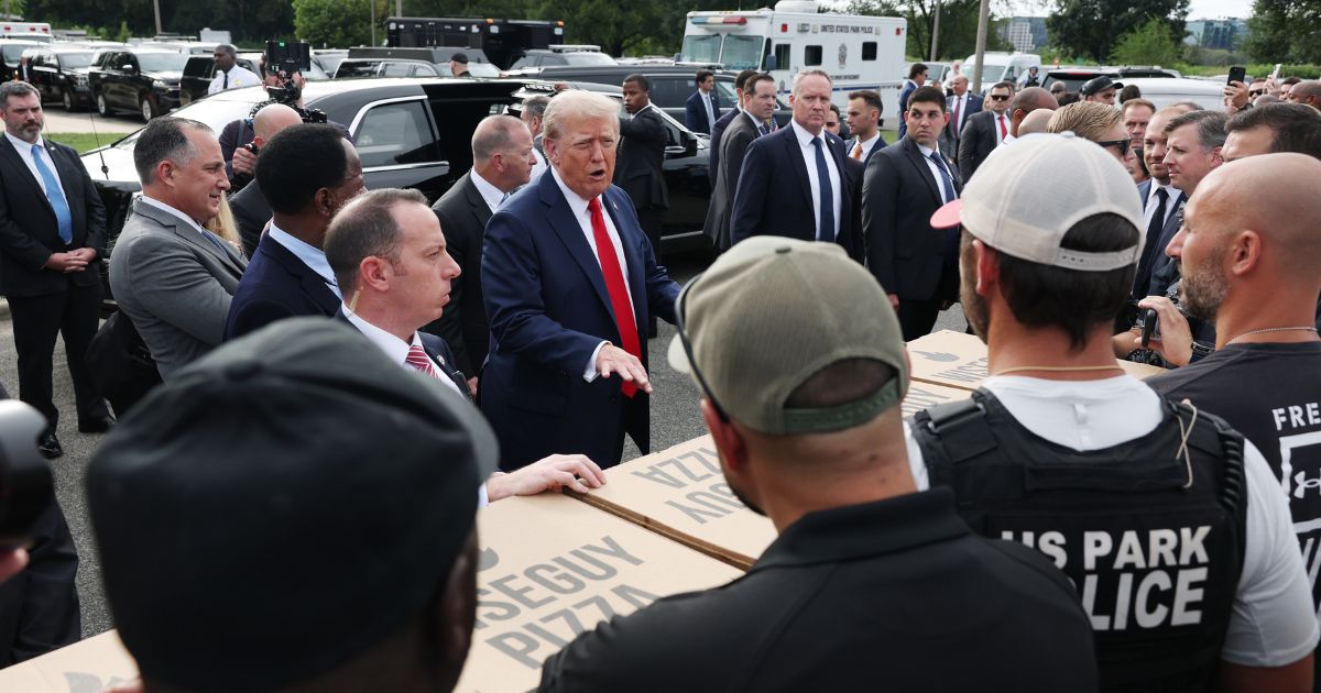 President Donald Trump, center, visits with law enforcement officers at the U.S. Park Police Anacostia Operations Facility in Washington, D.C., on Thursday.