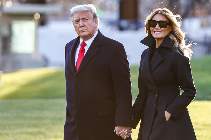 WASHINGTON, DC - DECEMBER 23: President Donald Trump and first lady Melania Trump walk on the south lawn of the White House on December 23, 2020 in Washington, DC. The Trumps are headed to Mar-a-Lago for the holidays with a government shutdown possible on Monday December 28. (Photo by Tasos Katopodis/Getty Images)