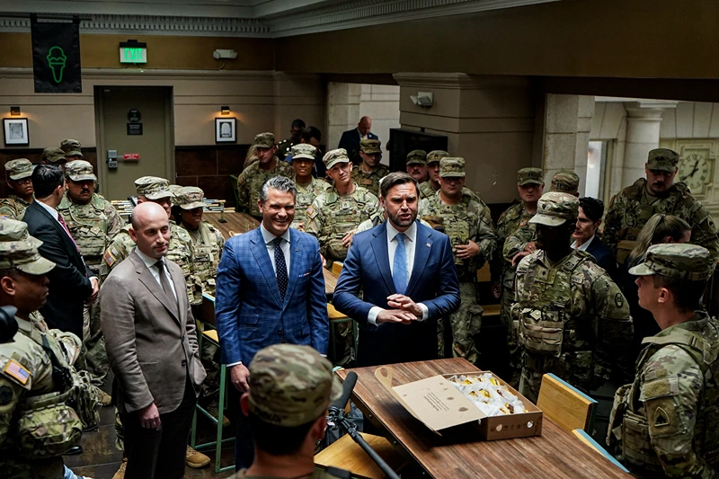 WASHINGTON, DC - AUGUST 20: (L-R) White House Deputy Chief of Staff Stephen Miller, Defense Secretary Pete Hegseth, and Vice President JD Vance speak with members of the National Guard during a visit to Union Station on August 20, 2025 in Washington, D.C. The Trump administration has deployed federal officers and the National Guard to the District in order to place the DC Metropolitan Police Department under federal control and assist in crime prevention in the nation