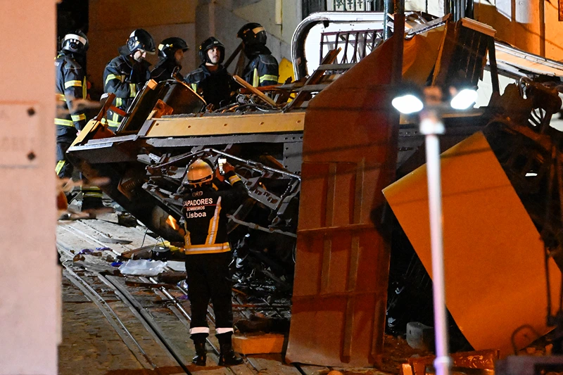 Firefighters work the scene at Gloria funicular derail site on September 03, 2025 in Lisbon, Portugal. Fifteen people were killed and around 20 injured when a car on the Glória Funicular derailed in Lisbon. The iconic funicular railway line, also called Elevador da Glória, connects Lisbon's Restauradores Square to the neighborhood of Bairro Alto via a steep 275 meter (900ft) climb, and is popular among tourists. (Photo by Horacio Villalobos/Getty Images)