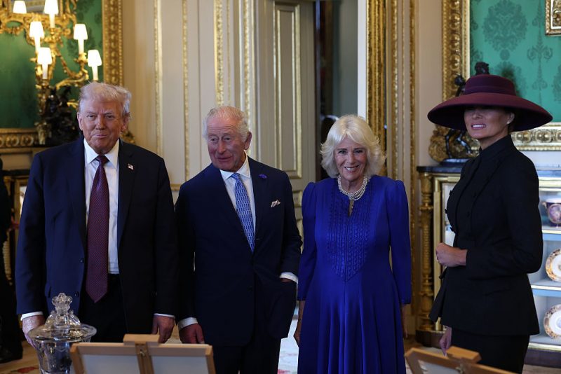 WINDSOR, ENGLAND - SEPTEMBER 17: US President Donald Trump, King Charles III, Queen Camilla and First Lady Melania Trump view items on display during a visit to the Royal Collection exhibition, in the Green Drawing Room during the State visit by the President of the United States of America at Windsor Castle on September 17, 2025 in Windsor, England. President Trump is in England from Sept. 16-18 on his second UK state visit, with the previous one taking place in 2019 during his first presidential term. (Photo by Anna Moneymaker/Getty Images)