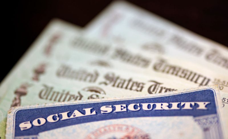 WASHINGTON, DC - OCTOBER 14: In this photo illustration, a Social Security card sits alongside checks from the U.S. Treasury on October 14, 2021 in Washington, DC. The Social Security Administration announced recipients will receive an annual cost of living adjustment of 5.9%, the largest increase since 1982. The larger increase is aimed at helping to offset rising inflation. (Photo illustration by Kevin Dietsch/Getty Images)