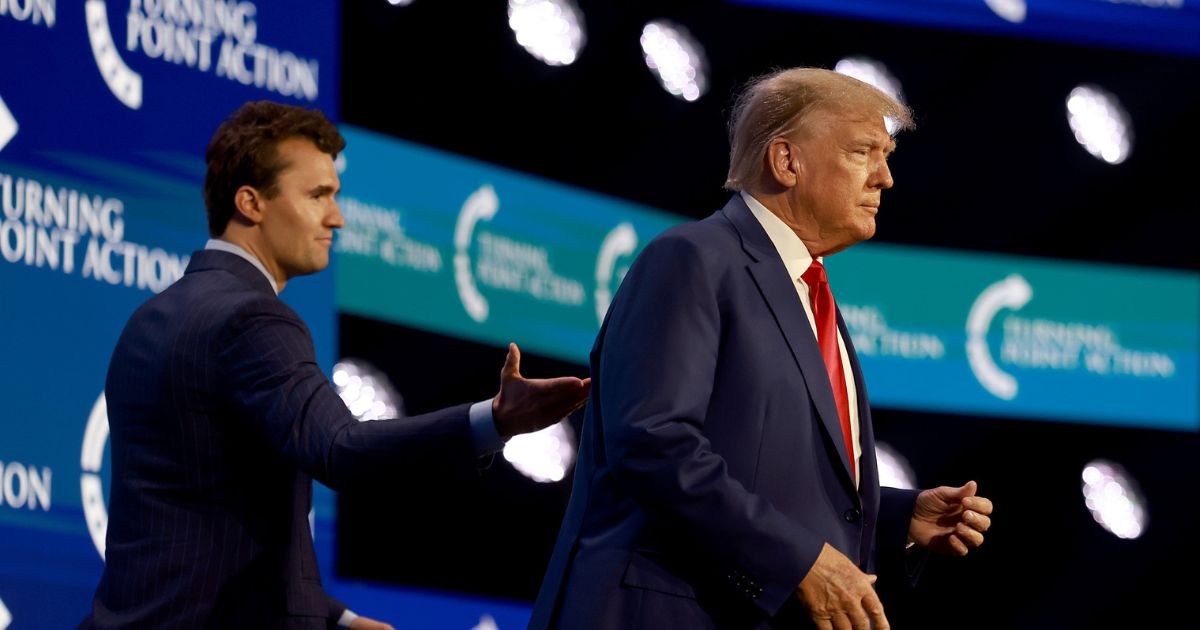 President Donald Trump walks on stage after being introduced by Charlie Kirk at the Turning Point Action conference as he continues his 2024 presidential campaign on July 15, 2023, in West Palm Beach, Florida.