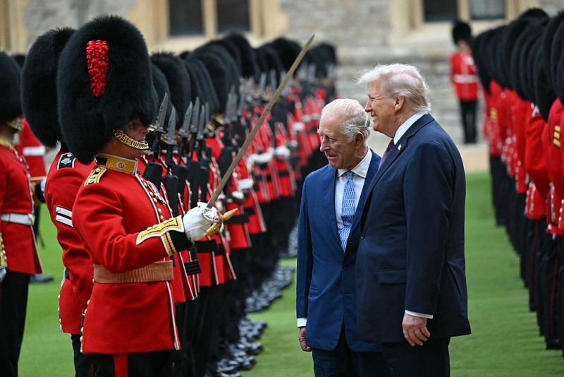Britain's King Charles III (C) and US President Donald Trump (R) talk with a Coldstream Guardsman as they inspect the guard of honour during a ceremonial welcome in the Quadrangle at Windsor Castle, in Windsor, on September 17, 2025, during the US president's second State Visit. US President Donald Trump arrived in Britain for an unprecedented second State Visit, with the UK government rolling out a royal red carpet welcome to win over the mercurial leader. (Photo by ANDREW CABALLERO-REYNOLDS / AFP) (Photo by ANDREW CABALLERO-REYNOLDS/AFP via Getty Images)