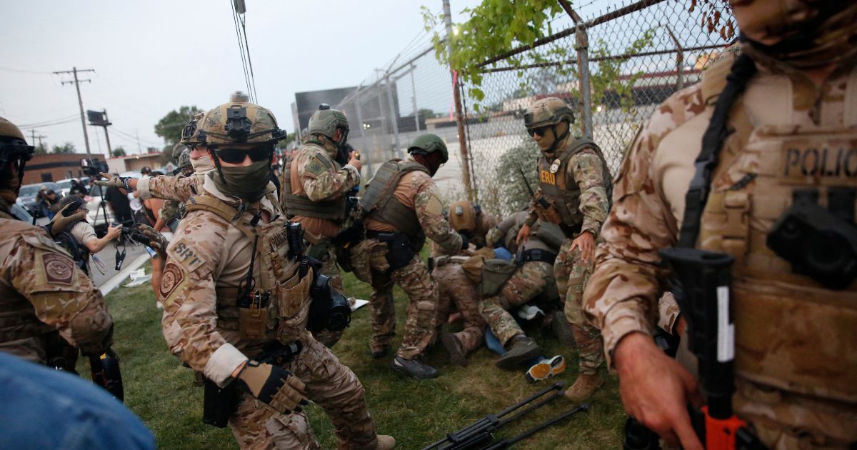 Immigration and Customs Enforcement and Enforcement and Removal Operations agents clash with demonstrators during a protest outside an ICE processing center in Broadview, Illinois, on Sept. 19, 2025.