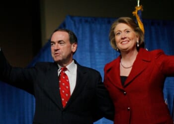 Then-Republican presidential candidate Mike Huckabee and his wife, Janet Huckabee, arrive at a post-primary campaign rally in Columbia, South Carolina, on Jan. 19, 2008.