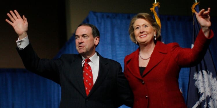 Then-Republican presidential candidate Mike Huckabee and his wife, Janet Huckabee, arrive at a post-primary campaign rally in Columbia, South Carolina, on Jan. 19, 2008.