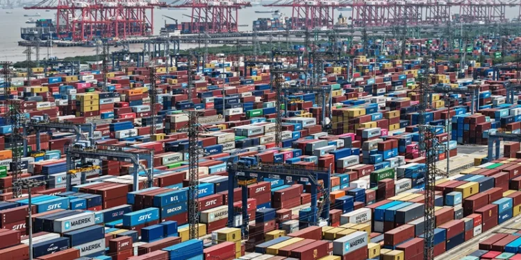 TOPSHOT - An aerial view shows cargo containers stacked at a port in Shanghai on April 20, 2025. (Photo by AFP) / China OUT (Photo by STR/AFP via Getty Images)