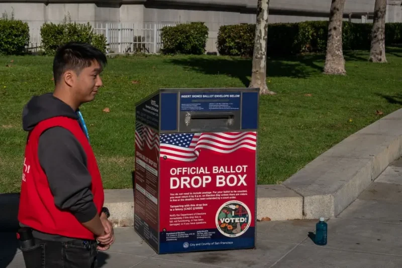 Poll workers stand by an official ballot drop box on the final day of early voting ahead of Election Day at City Hall on November 4, 2024 in San Francisco, California. Millions of Americans will cast their ballots tomorrow in the presidential race between Republican nominee former President Donald Trump and Democratic nominee Vice President Kamala Harris, as well as multiple state elections that will determine the balance of power in Congress. (Photo by Loren Elliott/Getty Images)