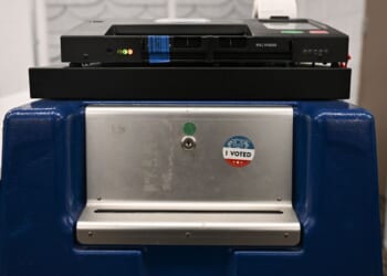 An "I Voted" sticker is displayed on the side of a box beneath a Dominion Voting Machines tabulator in Phoenix, Arizona, on June 3, 2024.