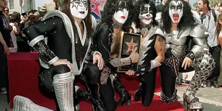 HOLLYWOOD, : Members of the rock band Kiss (from left to right): Ace Frehley, Paul Stanley, Peter Criss and Gene Simmons pose by the star they received during a Hollywood Walk of Fame ceremony 11 August 1999 in Hollywood, Ca. The group, known for their theatrical stage performances, has sold 80 million records over their 26 year career. AFP PHOTO/Vince BUCCI (Photo credit should read Vince Bucci/AFP via Getty Images)