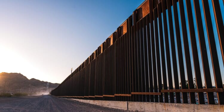 A service road sits next to the U.S. Southern Border Wall in El Paso, Texas.