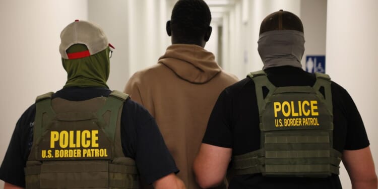 Federal agents detain a man after his court hearing in immigration court at the Ted Weiss Federal Building in New York City on July 9.