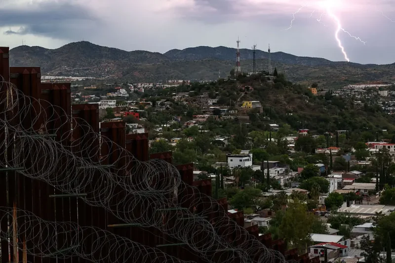 View of the US-Mexico border wall in Nogales, Arizona on September 17, 2025. As of 2022, approximately 11 million people lived in the United States illegally, according to government figures. And this figure may have risen since then to as many as 14 million, according to the Washington-based Migration Policy Institute. Undocumented workers paid $97 billion in taxes in 2022 alone, according to Americans for Tax Fairness. Figures from 2024 from the US Labor Department said nearly half of the foreign-born workforce in America is Latino. (Photo by CHARLY TRIBALLEAU / AFP) (Photo by CHARLY TRIBALLEAU/AFP via Getty Images)