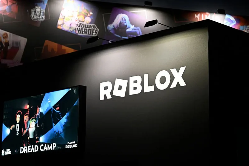 A photo shows the logo of online game platform and game creation system Roblox at their booth during at the Gamescom video games trade fair at the Trade Fair Center in Cologne, western Germany, on August 21, 2025. The 2025 edition of the vast Gamescom trade fair in Cologne, Germany, had its opening night on August 19, 2025 and will be running from August 20 to 24, 2025. (Photo by Ina FASSBENDER / AFP) (Photo by INA FASSBENDER/AFP via Getty Images)