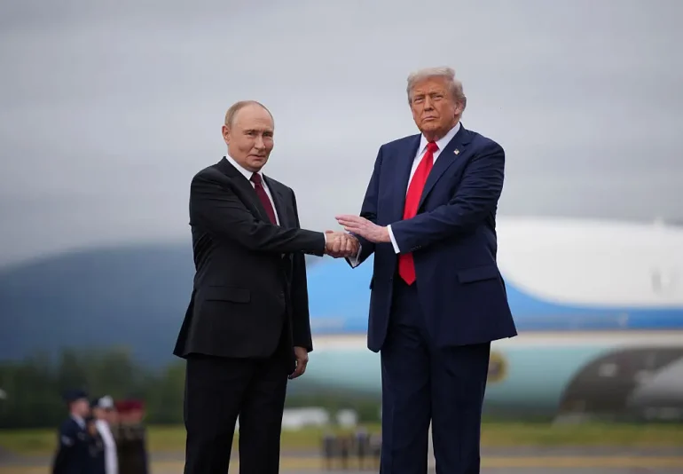 ANCHORAGE, ALASKA - AUGUST 15: U.S. President Donald Trump (R) greets Russian President Vladimir Putin as he arrives at Joint Base Elmendorf-Richardson on August 15, 2025 in Anchorage, Alaska. The two leaders are meeting for peace talks aimed at ending the war in Ukraine. (Photo by Andrew Harnik/Getty Images)