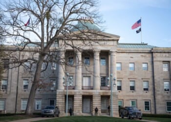 Law enforcement stand guard outside of the state capitol building in downtown Raleigh, North Carolina, on January 17, 2021, during a nationwide protest called by anti-government and far-right groups supporting US President Donald Trump and his claim of electoral fraud in the November 3 presidential election. - The FBI warned authorities in all 50 states to prepare for armed protests at state capitals in the days leading up to the January 20 presidential inauguration of President-elect Joe Biden. (Photo by Logan Cyrus / AFP) (Photo by LOGAN CYRUS/AFP via Getty Images)