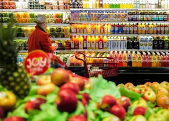 Fruit is displayed as a woman shops in a supermarket in the Manhattan borough of New York city on January 27, 2024. (Photo by Charly TRIBALLEAU / AFP) (Photo by CHARLY TRIBALLEAU/AFP via Getty Images)
