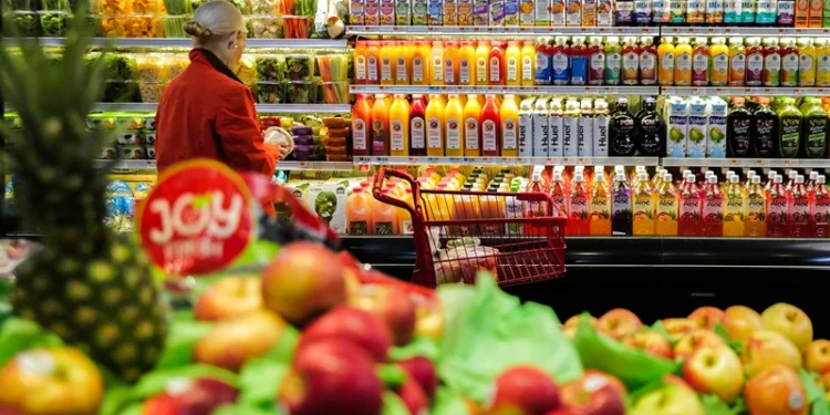 Fruit is displayed as a woman shops in a supermarket in the Manhattan borough of New York city on January 27, 2024. (Photo by Charly TRIBALLEAU / AFP) (Photo by CHARLY TRIBALLEAU/AFP via Getty Images)