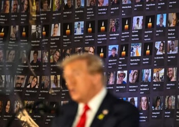 TOPSHOT - Pictures of hostages and victims are seen as former US President and Republican presidential candidate Donald Trump speaks during a remembrance event to mark the first anniversary of the Hamas attack on Israel at Trump National Doral golf club in Miami, Florida, on October 7, 2024. (Photo by CHANDAN KHANNA / AFP) (Photo by CHANDAN KHANNA/AFP via Getty Images)