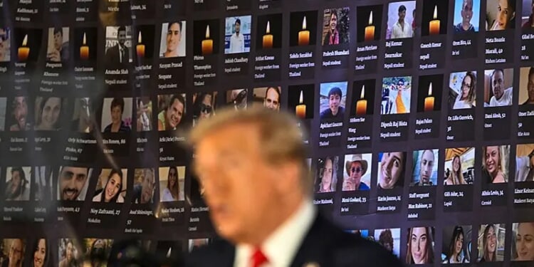 TOPSHOT - Pictures of hostages and victims are seen as former US President and Republican presidential candidate Donald Trump speaks during a remembrance event to mark the first anniversary of the Hamas attack on Israel at Trump National Doral golf club in Miami, Florida, on October 7, 2024. (Photo by CHANDAN KHANNA / AFP) (Photo by CHANDAN KHANNA/AFP via Getty Images)