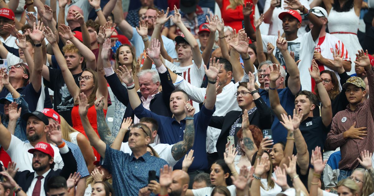 Attendees sing worship songs prior to the start of a memorial service for Charlie Kirk in Glendale, Arizona, on Sept. 21.