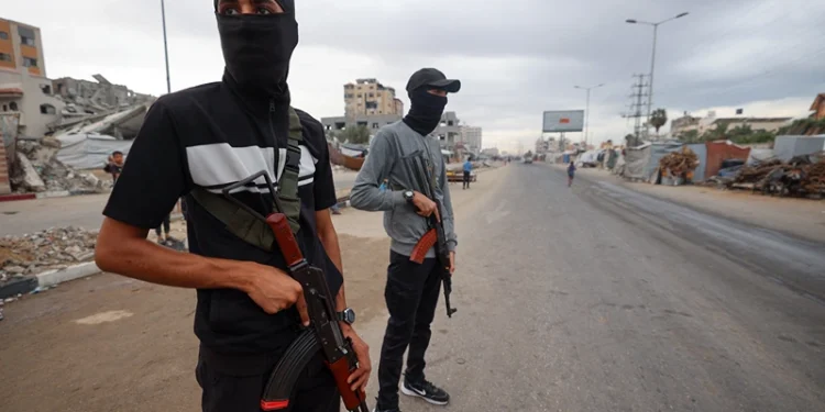 Members of the internal security forces loyal to the Palestinian group Hamas, man a checkpoint in the Nuseirat refugee camp in the central Gaza Strip, on October 12, 2025. Israel declared a ceasefire in Gaza and began to pull back its forces on October 10, as tens of thousands of exhausted Palestinians made their way back to their devastated homes. (Photo by Eyad BABA / AFP) (Photo by EYAD BABA/AFP via Getty Images)