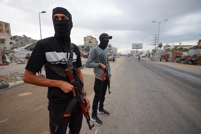 Members of the internal security forces loyal to the Palestinian group Hamas, man a checkpoint in the Nuseirat refugee camp in the central Gaza Strip, on October 12, 2025. Israel declared a ceasefire in Gaza and began to pull back its forces on October 10, as tens of thousands of exhausted Palestinians made their way back to their devastated homes. (Photo by Eyad BABA / AFP) (Photo by EYAD BABA/AFP via Getty Images)