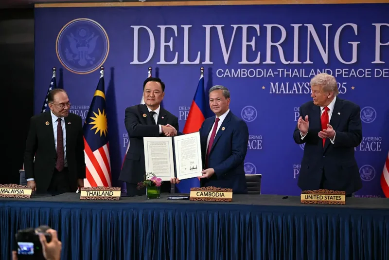 US President Donald Trump (R) claps as Thailand's Prime Minister Anutin Charnvirakul (2nd L) shakes hands with Cambodia's Prime Minister Hun Manet (2nd R) as Malaysia's Prime Minister Anwar Ibrahim during a ceremonial signing of a ceasefire agreement between Cambodia and Thailand on the sidelines of the 47th Association of Southeast Asian Nations (ASEAN) Summit in Kuala Lumpur on October 26, 2025. (Photo by ANDREW CABALLERO-REYNOLDS / AFP) (Photo by ANDREW CABALLERO-REYNOLDS/AFP via Getty Images)