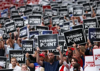 GLENDALE, ARIZONA - SEPTEMBER 21: Attendees hold up Turning Point USA signs at the memorial service for political activist Charlie Kirk at State Farm Stadium on September 21, 2025 in Glendale, Arizona. Kirk, the CEO and co-founder of Turning Point USA, was shot and killed on September 10th while speaking at an event during his "American Comeback Tour" at Utah Valley University. (Photo by Eric Thayer/Getty Images)
