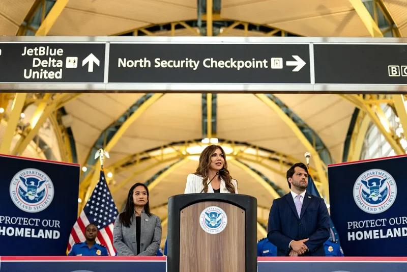 ARLINGTON, VA - JULY 8: U.S. Secretary of Homeland Security Kristi Noem, flanked by Deputy Administrator of the Transportation Security Administration Ha McNeil and Adam Stahl, TSA Senior Official Performing the Duties of the Administrator, speaks during a news conference at Ronald Reagan Washington National Airport on July 8, 2025 in Arlington, Virginia. For the first time in nearly two decades, the TSA is easing its shoe removal rule introduced five years after a 2001 shoe-bombing attempt by allowing some travelers to keep their shoes on at security checkpoints. (Photo by Kent Nishimura/Getty Images)