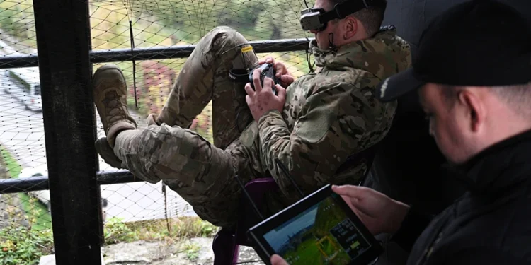 A Ukrainian serviceman (L) operates a drone during the