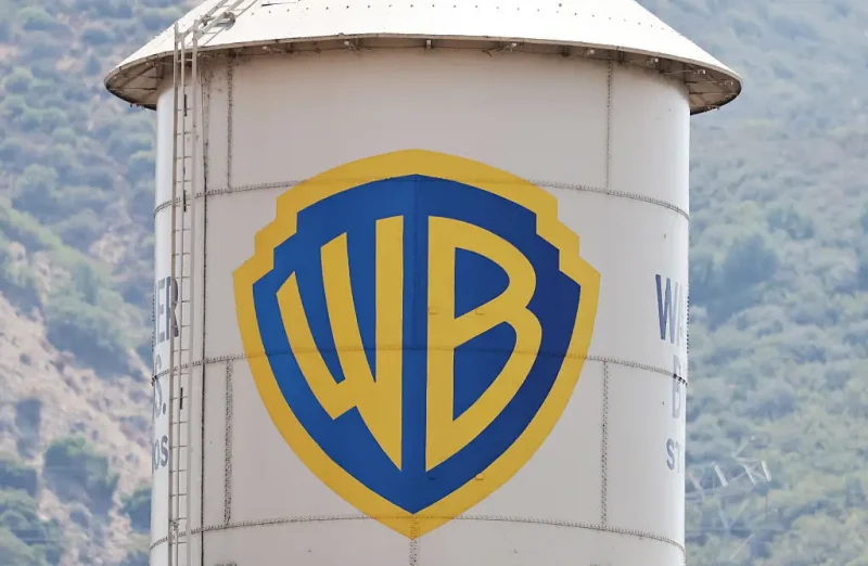 BURBANK, CALIFORNIA - SEPTEMBER 12: The Warner Bros. logo is displayed on a water tower at Warner Bros. Studio on September 12, 2025 in Burbank, California. Media giant Paramount Skydance is reportedly preparing a bid to purchase Warner Bros. Discovery, including its movie studio and cable networks. (Photo by Mario Tama/Getty Images)